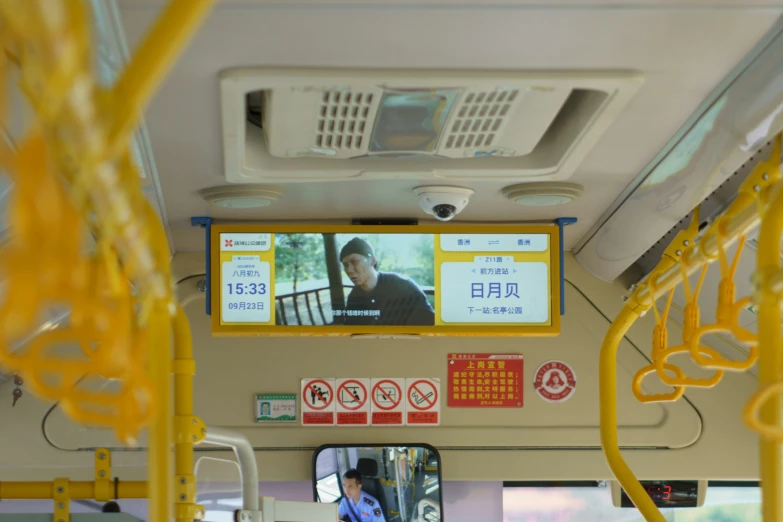 two screens are posted above the seats on a bus