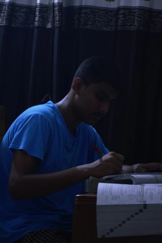 a young man using a laptop on a desk