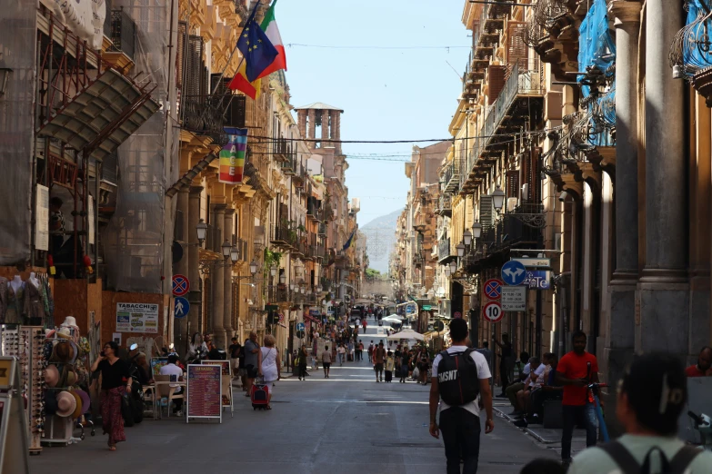 a city street with people walking down the center