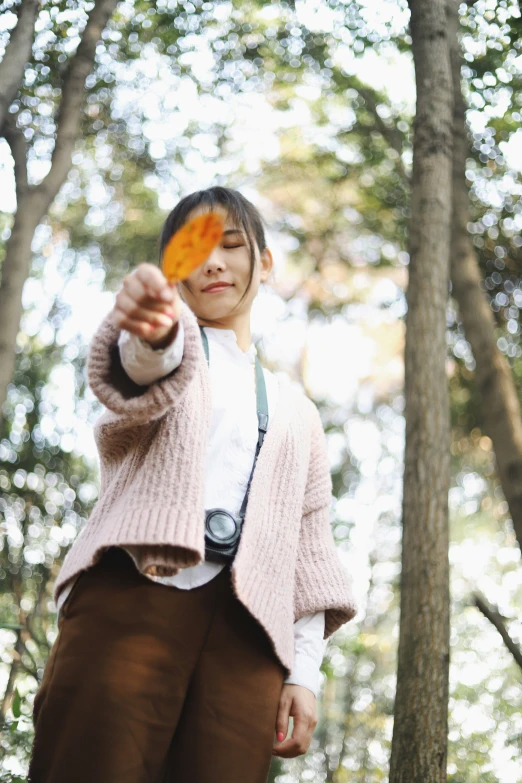 an asian girl taking a picture with her camera