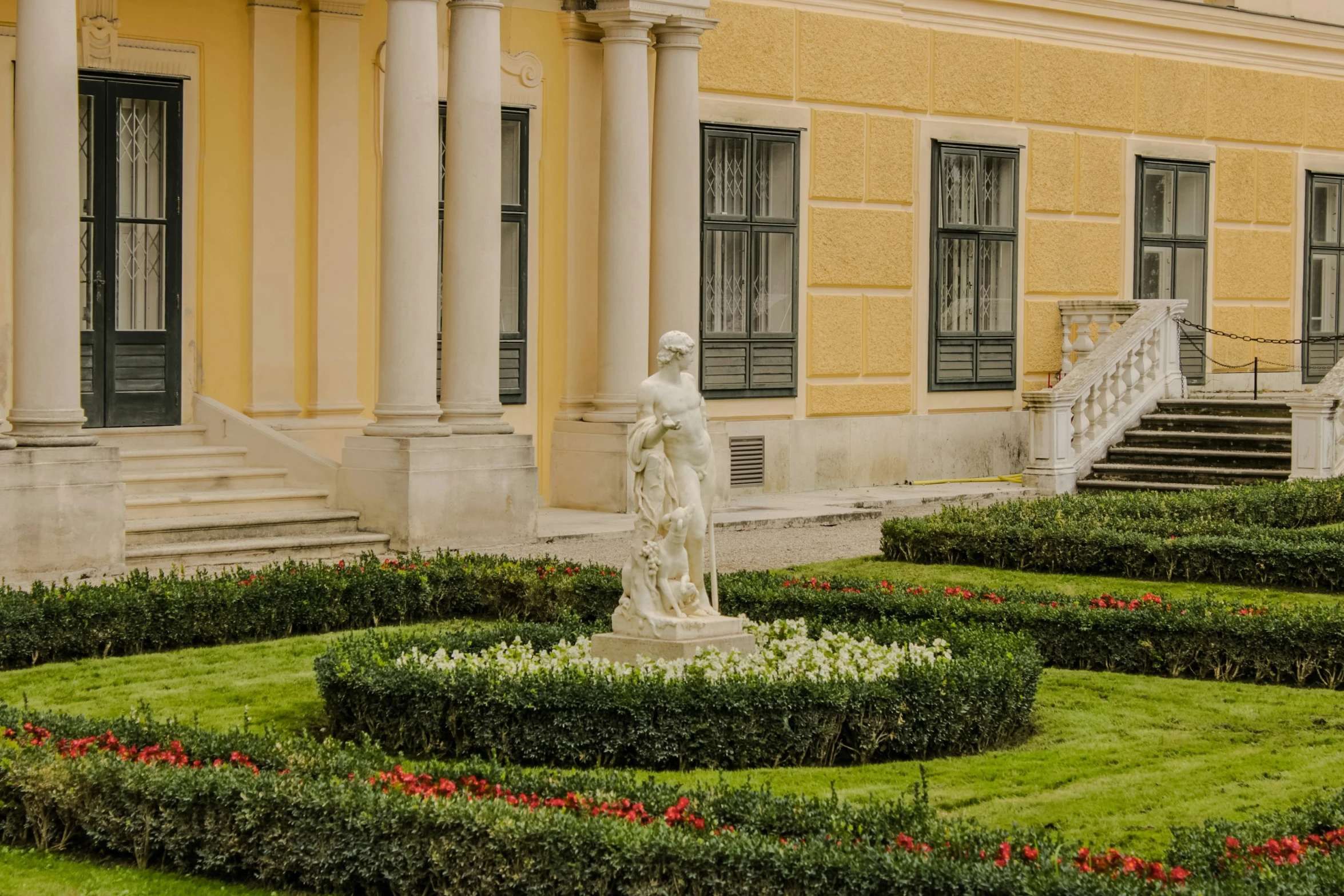 an ornate garden with a statue in the center