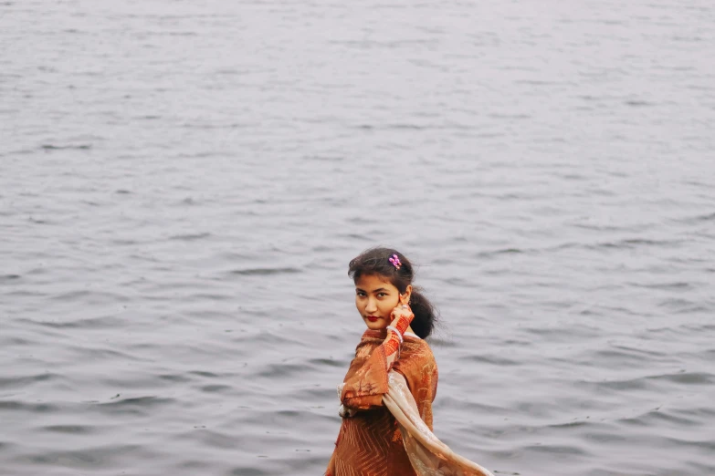 girl standing next to the water on the boat