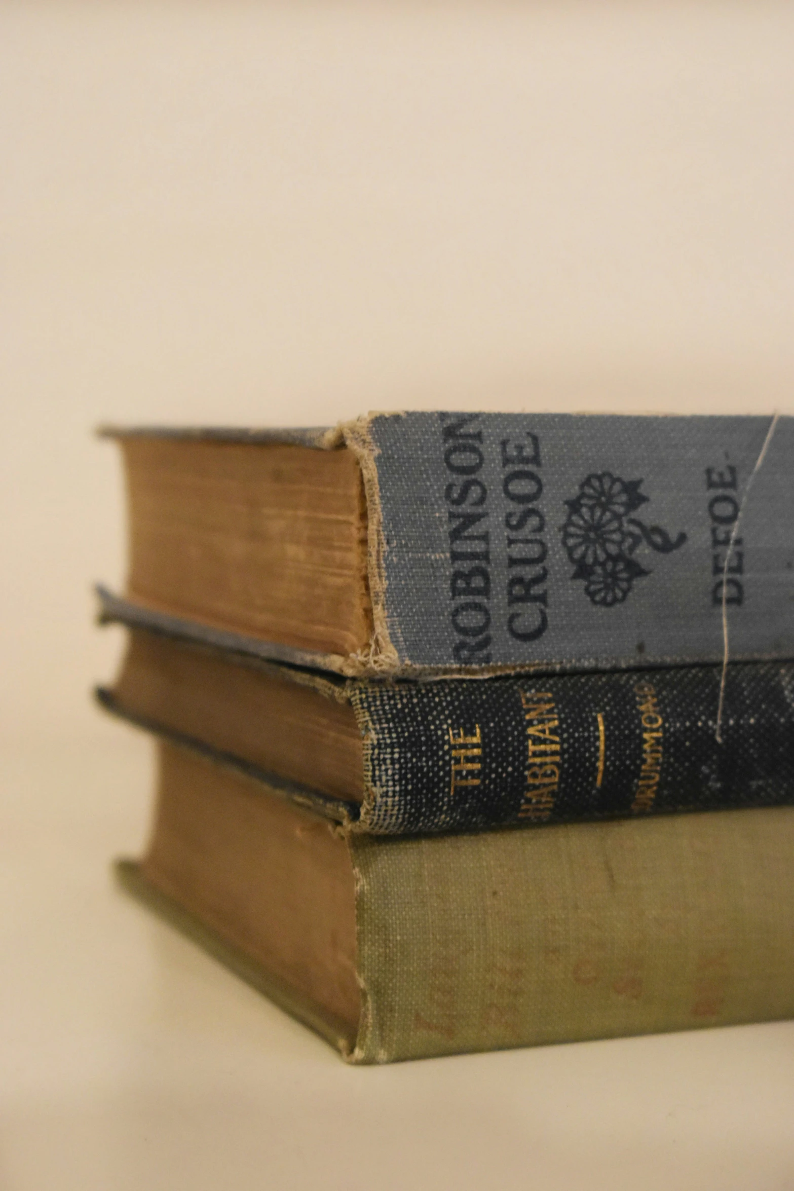 there are three books sitting side by side on the table