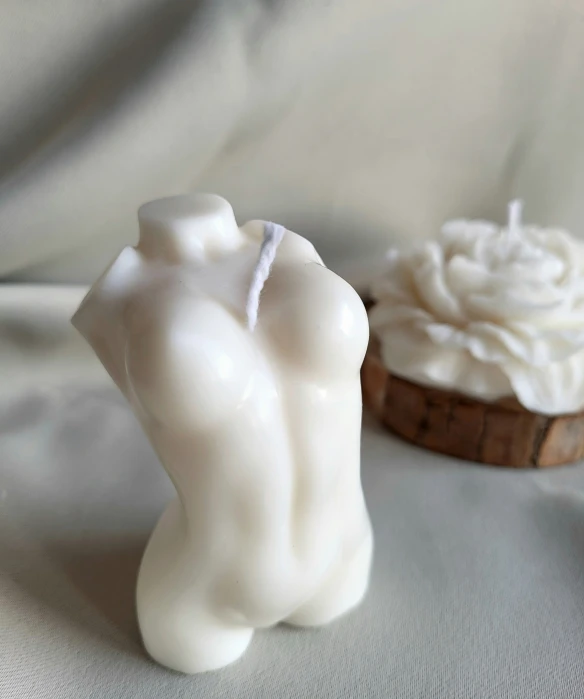 small statue with white icing on top of white fabric