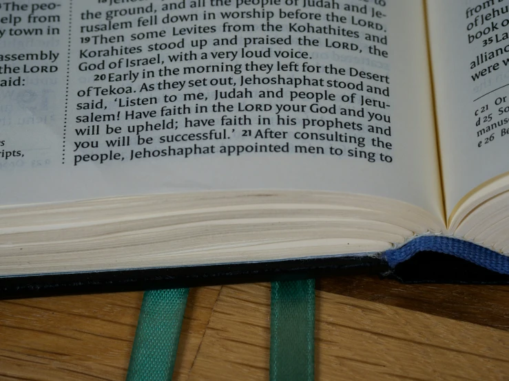 open bible on a table top with a cloth over it