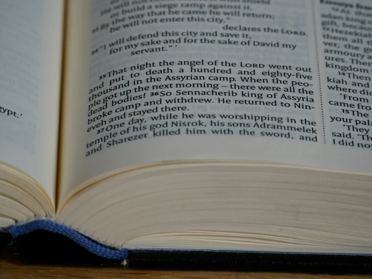 an open book on the top of a wooden table