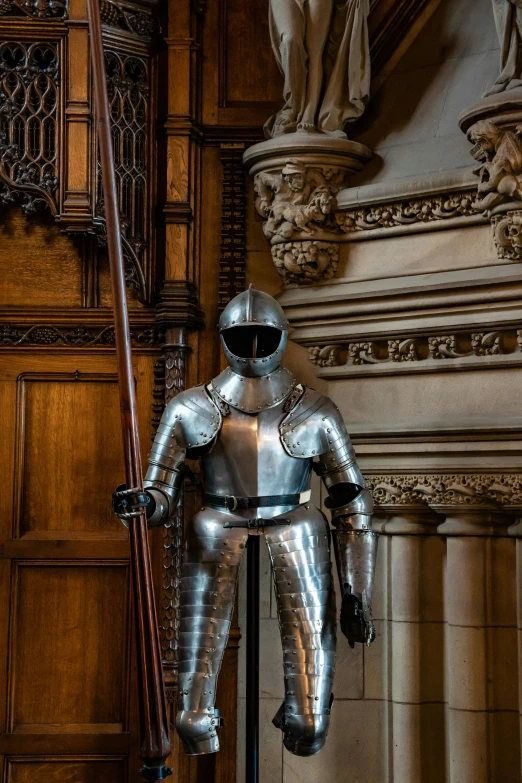 an armored person stands next to a door