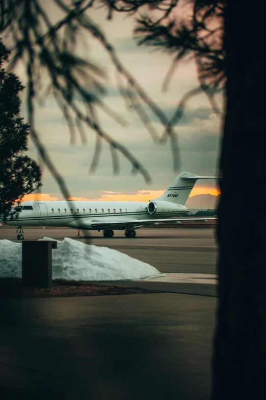 airplane landing on tarmac and a building to the side