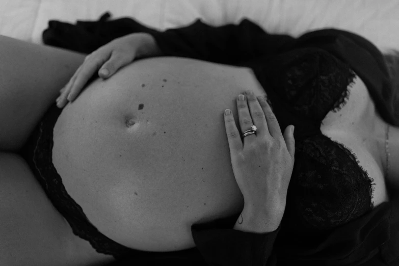 a pregnant woman is holding her stomach over her belly