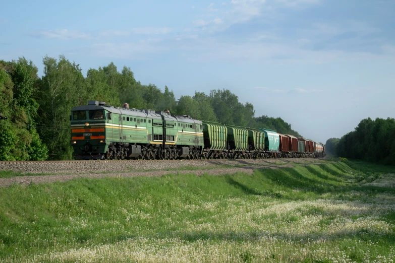 a train with multiple engines passes through trees