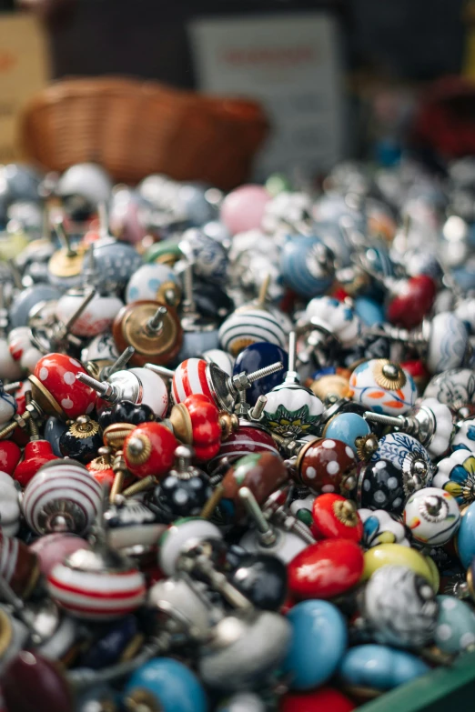 several balls are piled in a box on display