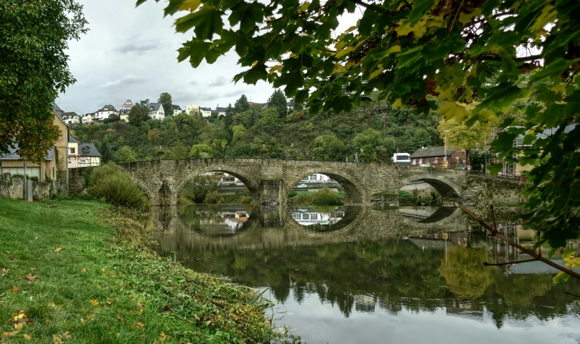 a bridge crosses a river in a rural setting