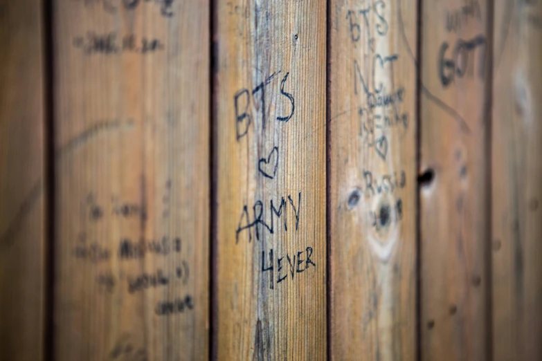 this is an image of wooden walls with graffiti on them