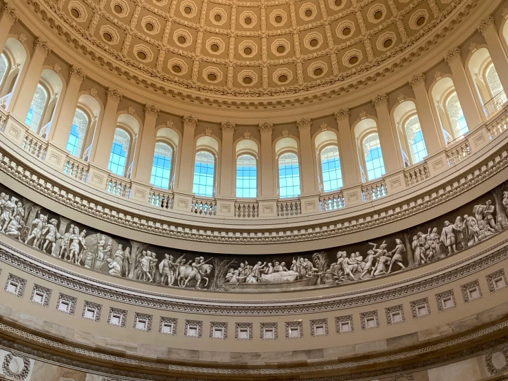 a round building has columns and windows inside