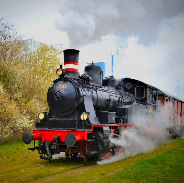 an old fashioned steam engine with smoke comes out