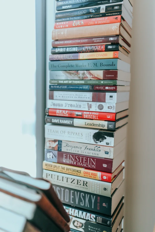 a stack of books sitting on top of a wooden floor