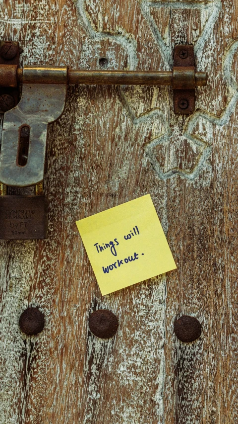 a post on the door of a house that has been vandalized with graffiti