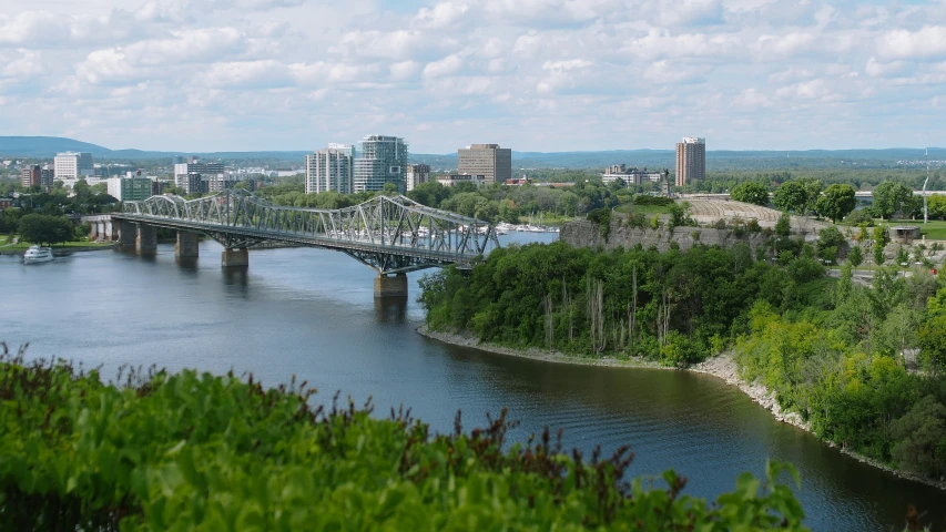 a bridge is over water near a city