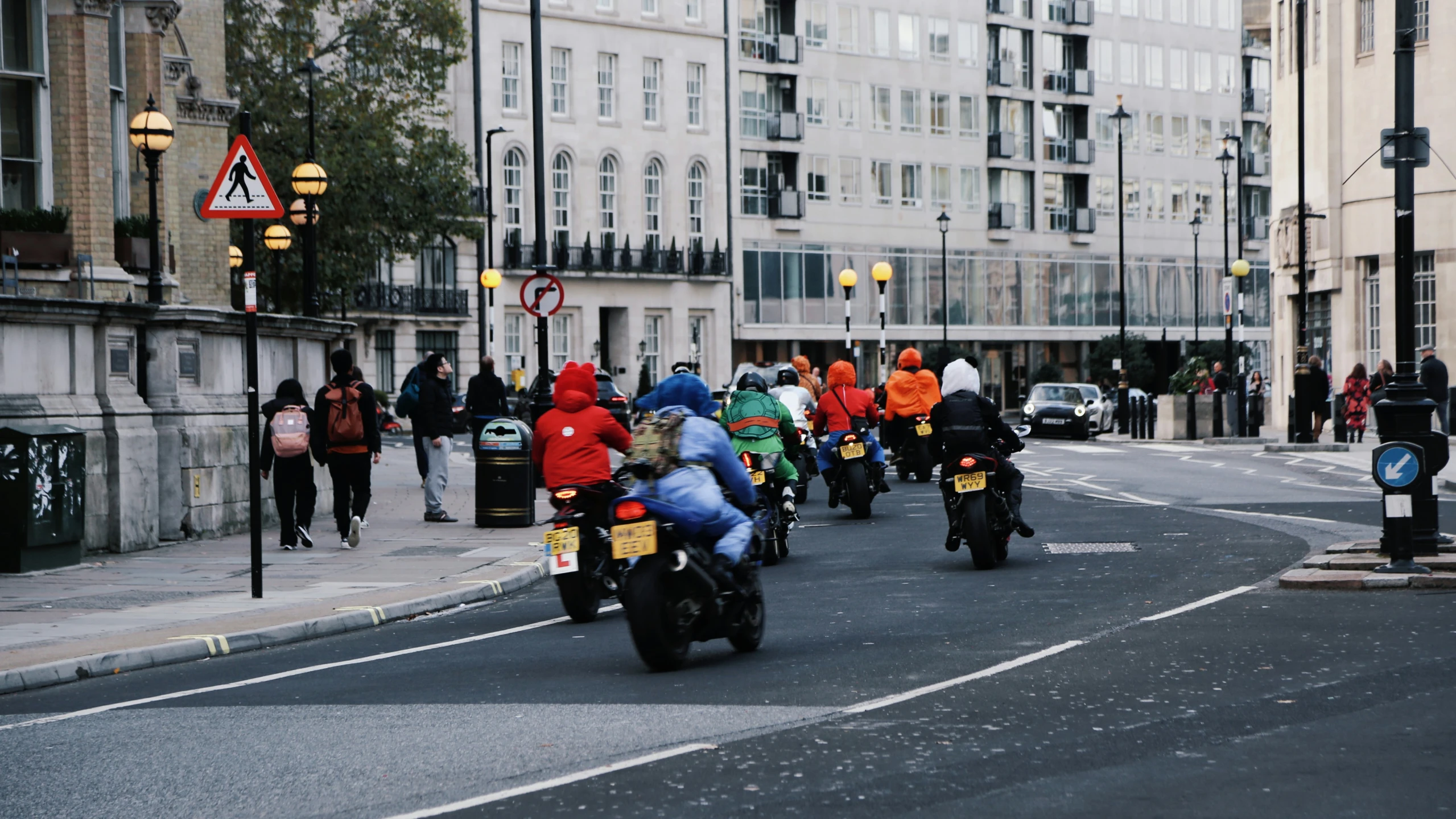 a group of motorcyclists going down the road