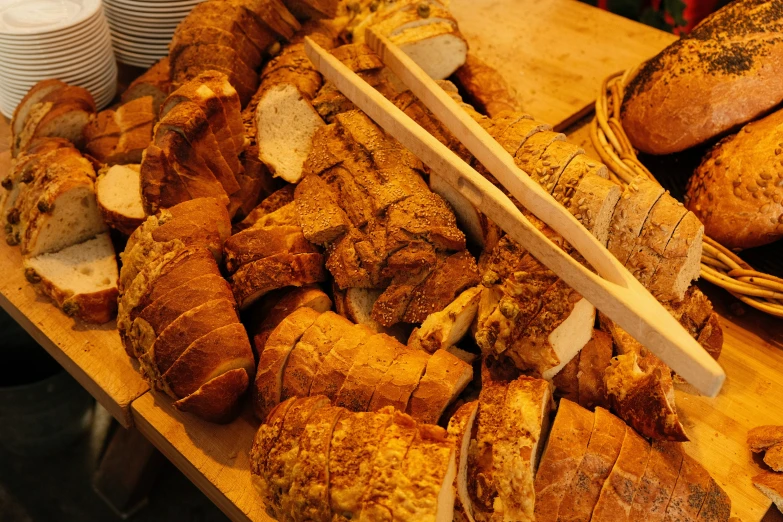 wooden  board topped with slices of bread and loaves of bread