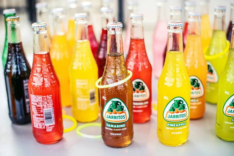 colorful bottles with orange, pink and green flavors