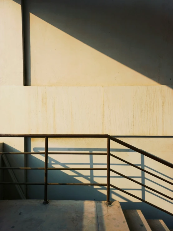 a concrete building with a steel railing next to it