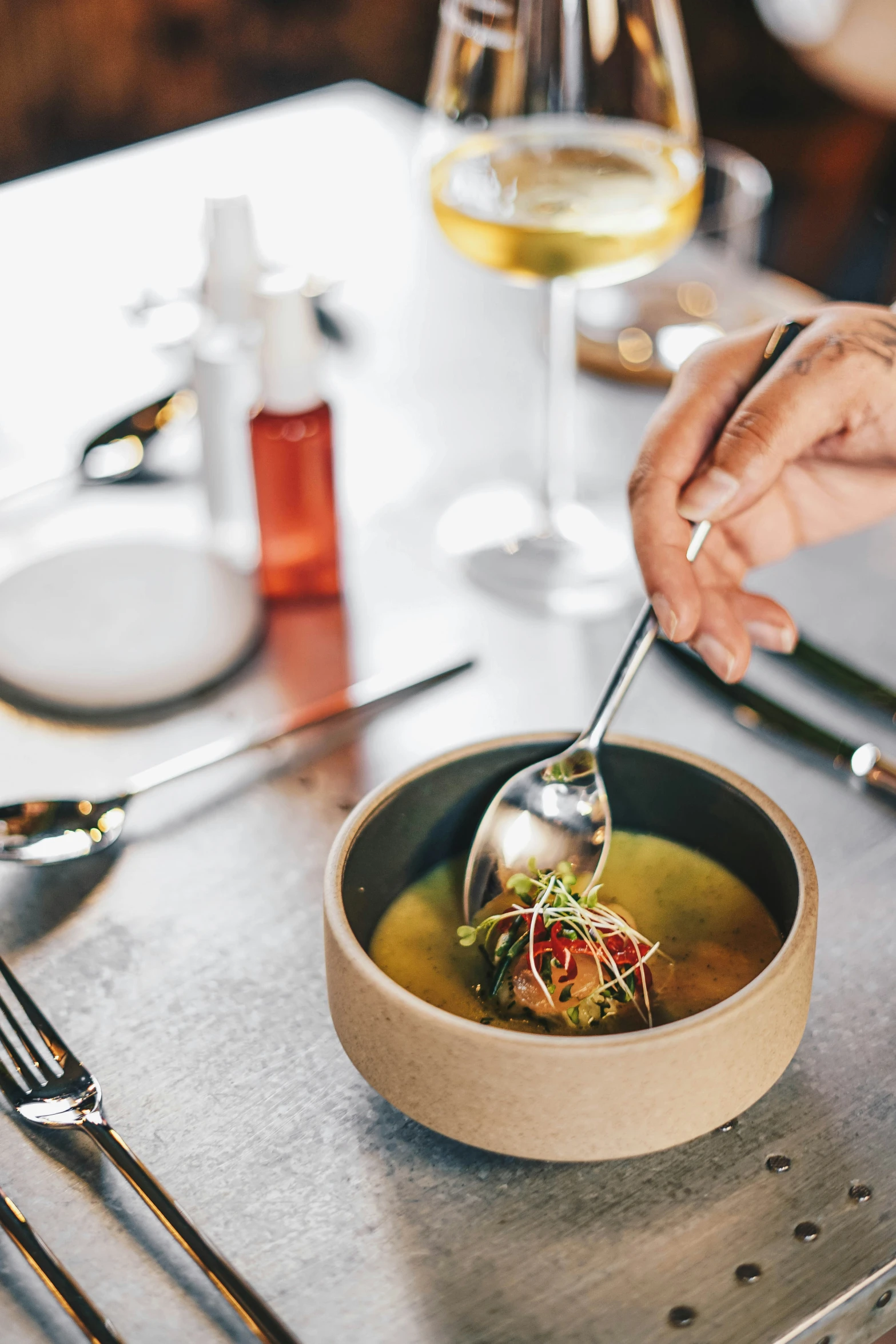 a bowl of soup with a spoon in it being served