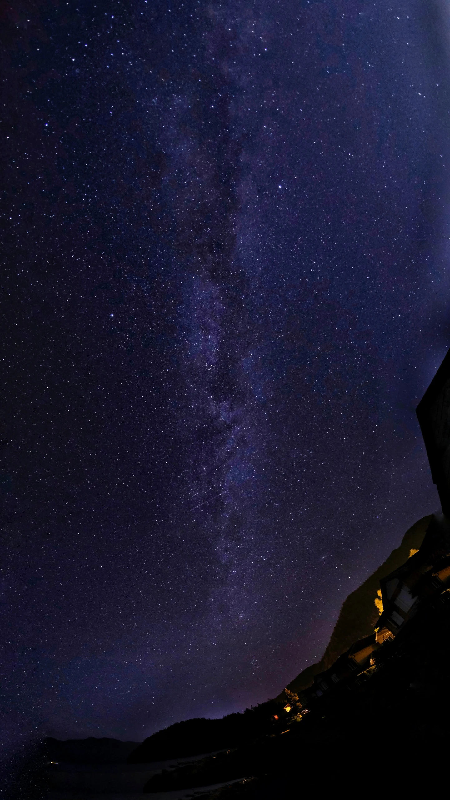 a lighthouse with a clear night sky with stars