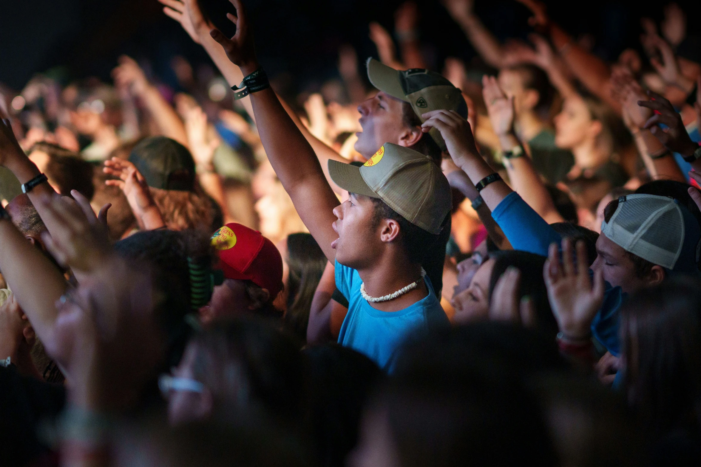 people are standing in the audience with their hands up