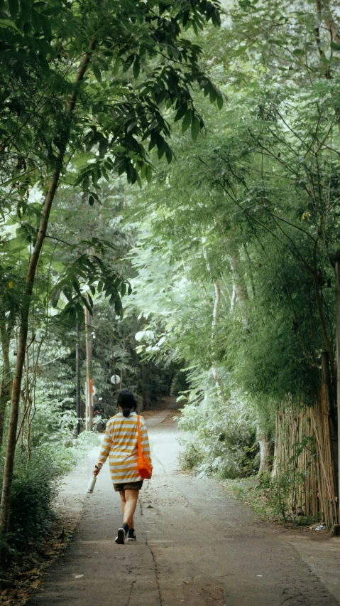 a young woman carrying a large wooden pole in her hand