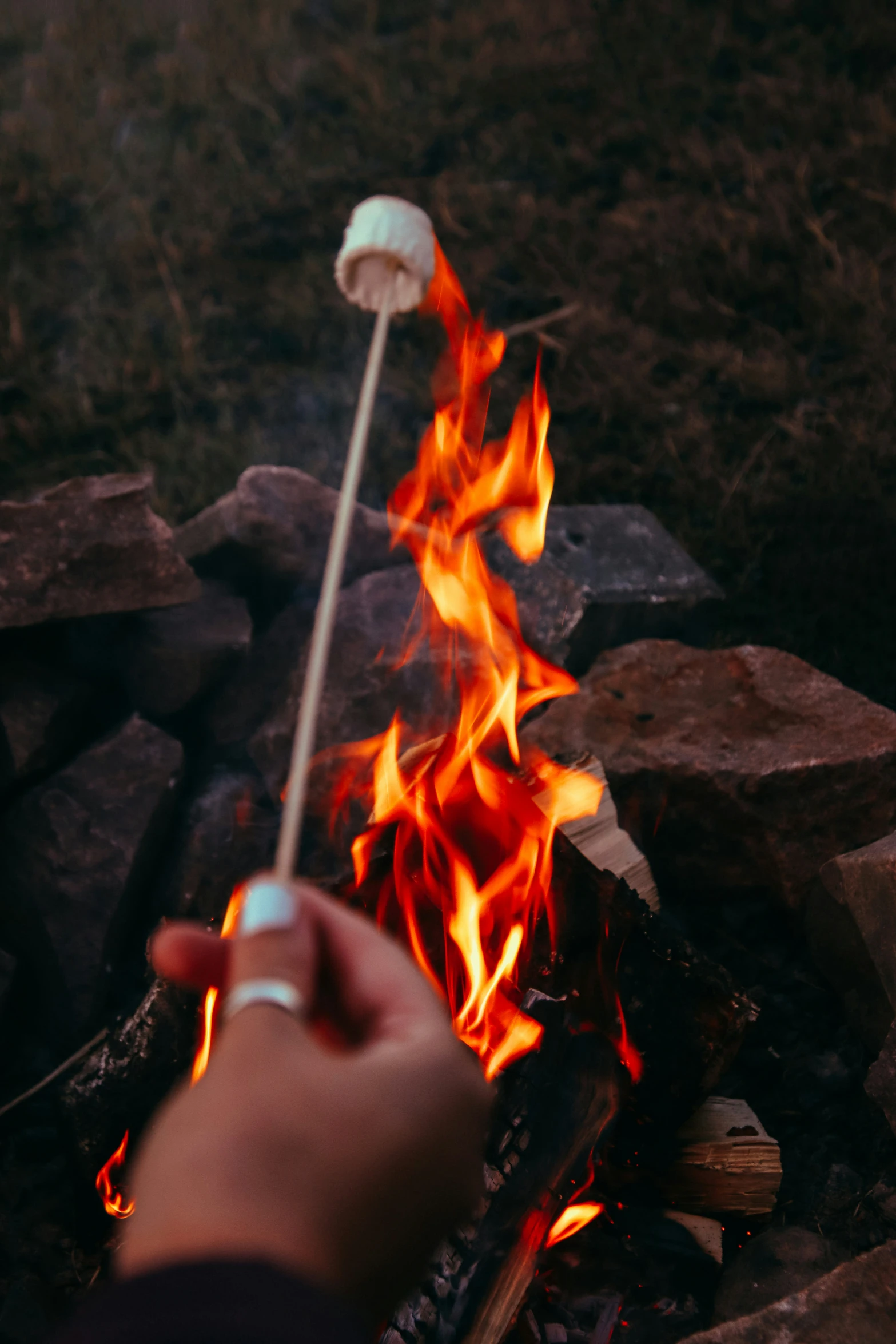 someone is lighting a match on an open fire