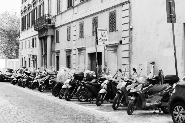 motorbikes are lined up on the side of a street