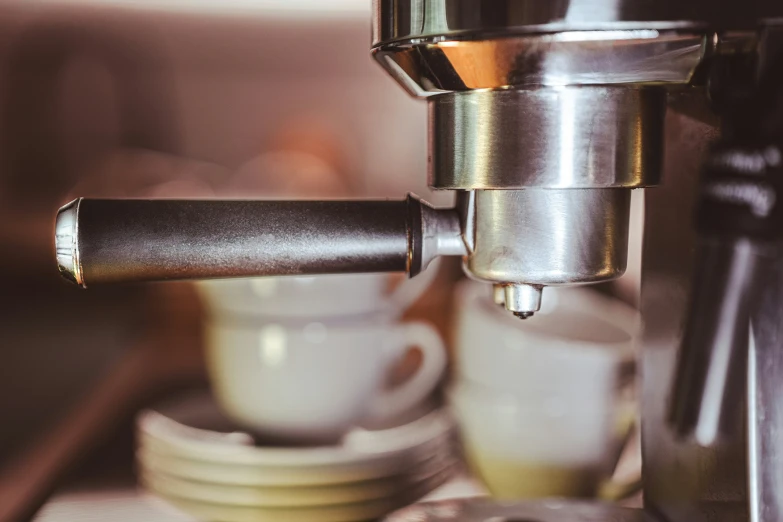 a cup being filled by an espresso machine