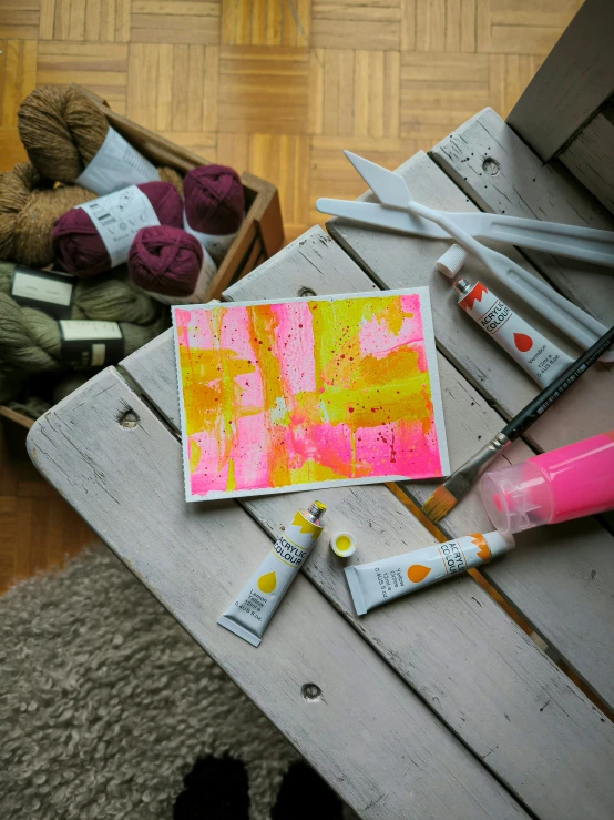 a pile of craft supplies sitting on top of a wooden table