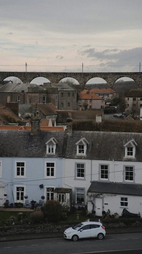 an old building with dorm roofs is in a city