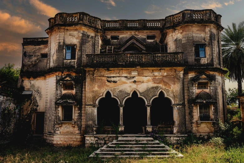 an old abandoned house with some steps and arches in front