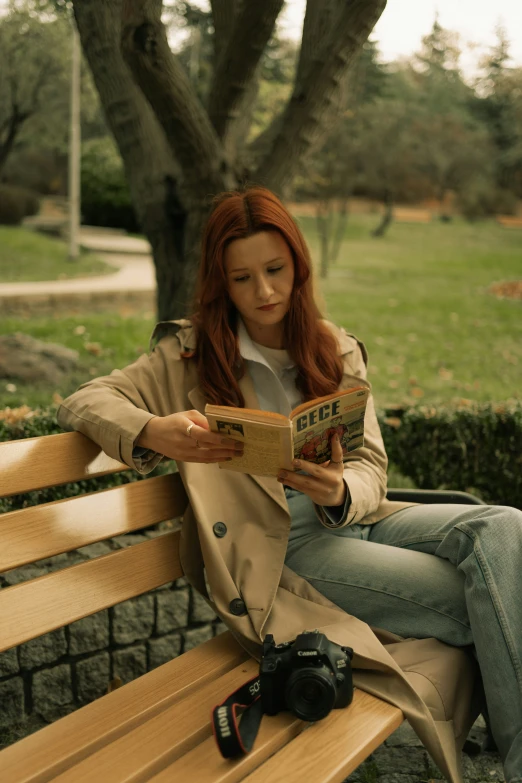 a woman is reading while sitting on a bench