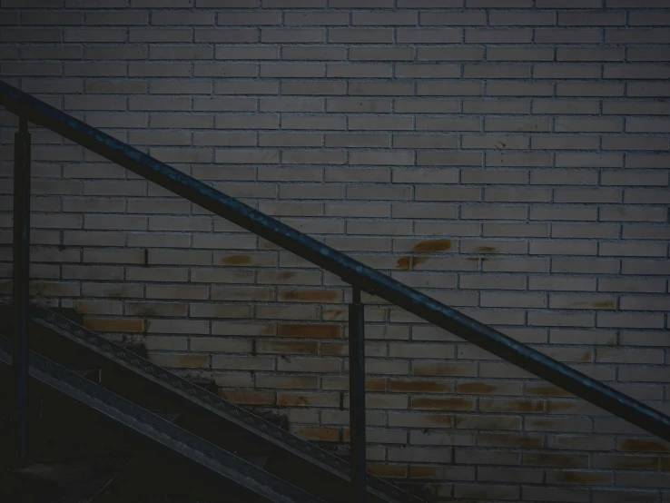 the stairs are made of brick and lead up to the brick wall