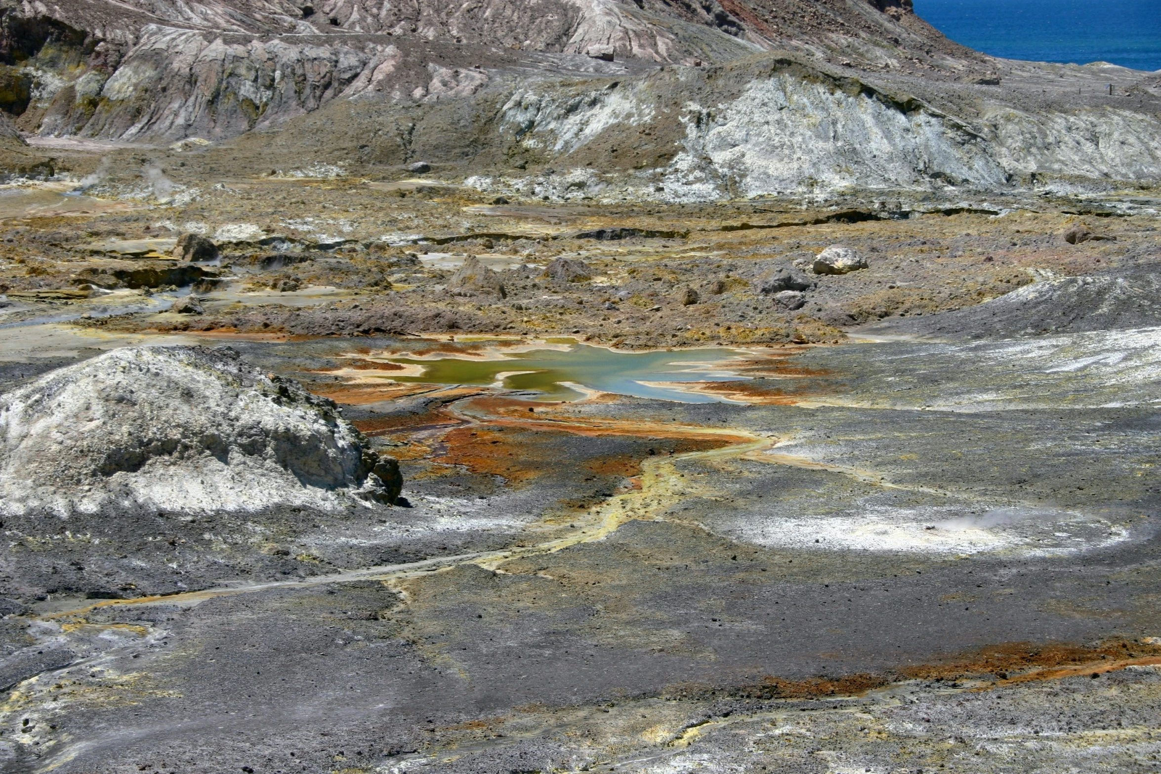 there is a patch of water that appears to be near a mountain