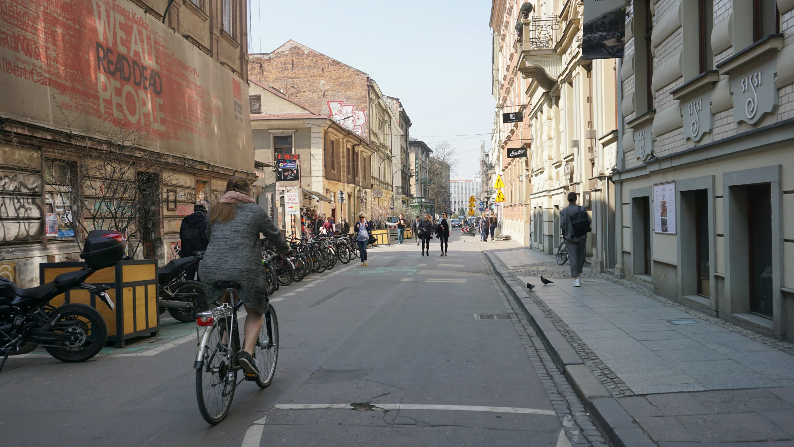 a woman riding a bicycle on a street