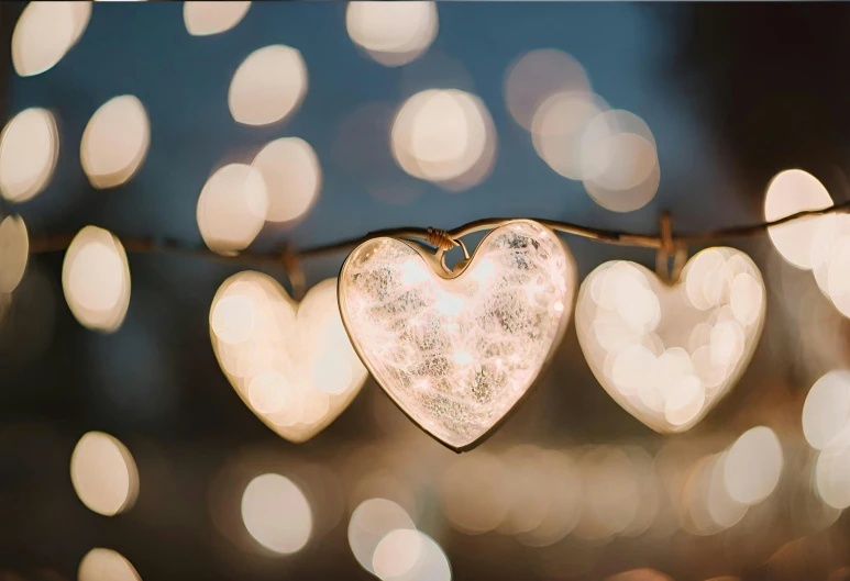 a small heart ornament hanging on a wire