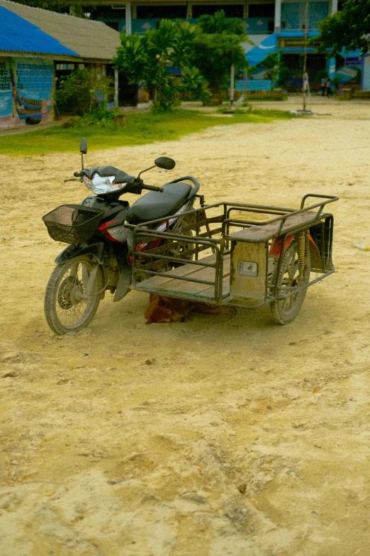 a motorbike with two carts and a cart on the back