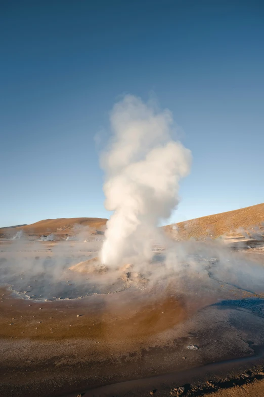 a geyser spewing water with its steam coming from it