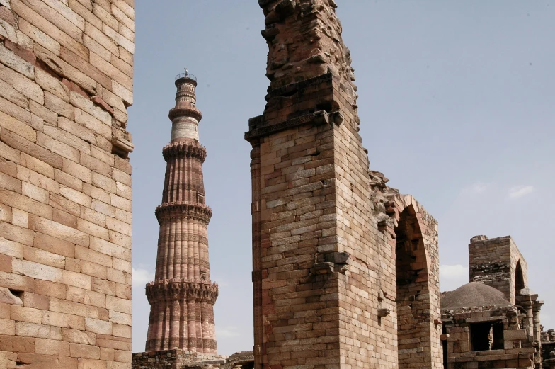 a large brick tower next to a tall building