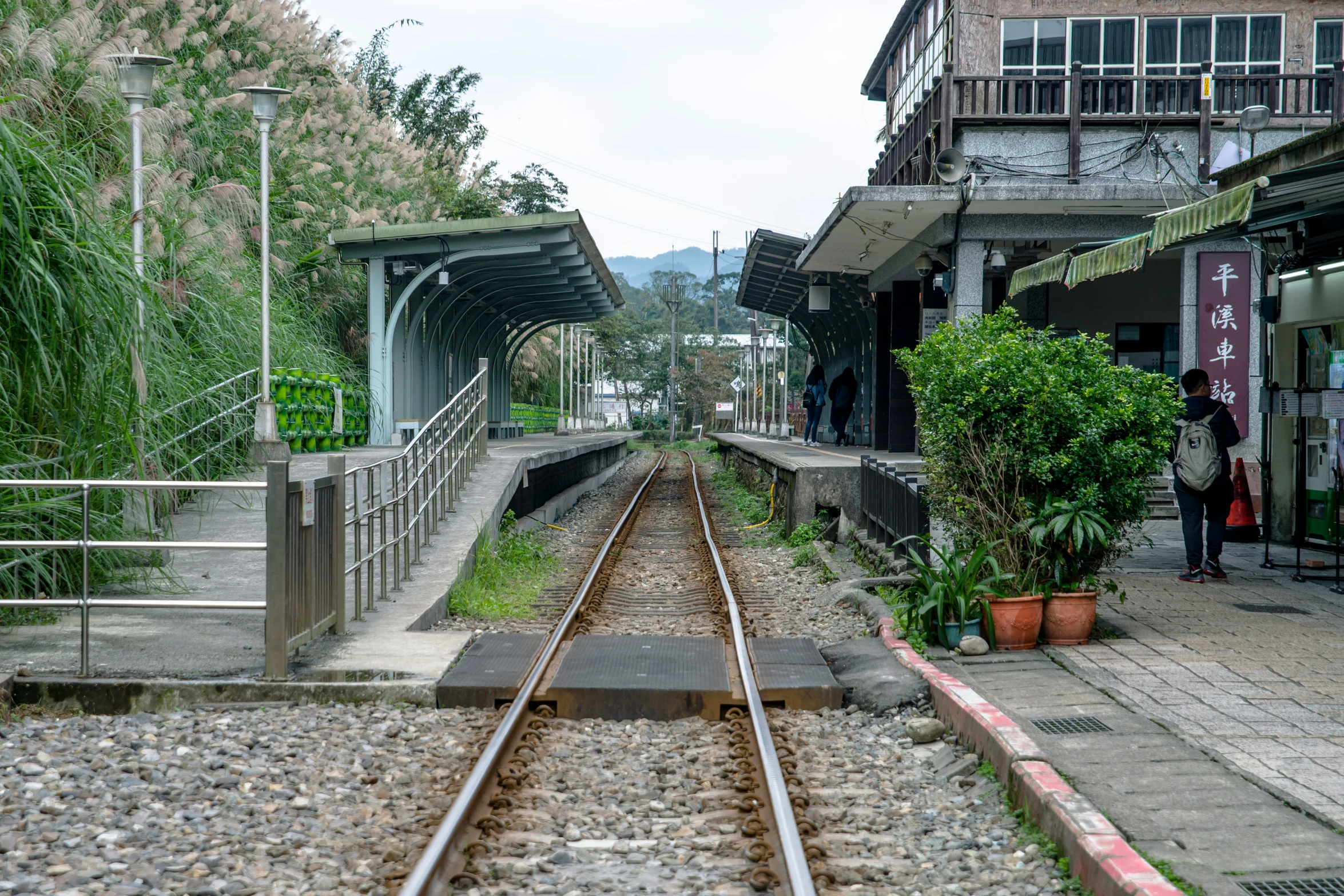 people on the train tracks at a train station