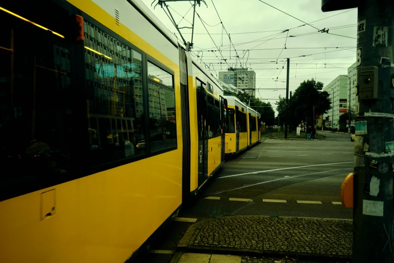 a passenger train on a city street with buildings