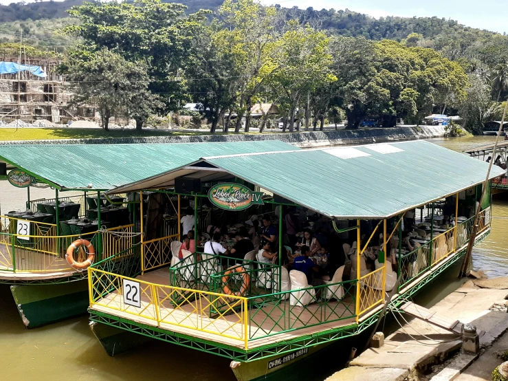 there is an image of a ferry boat docked at the river