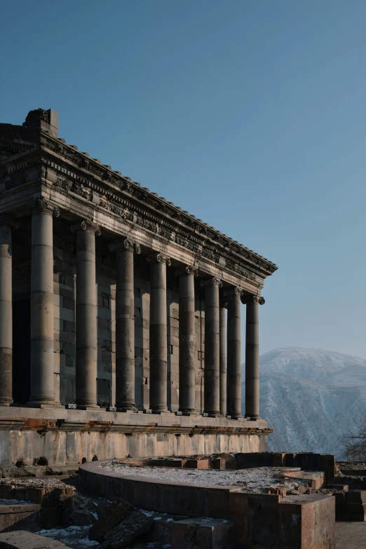 old ruins and columns in the middle of a mountain