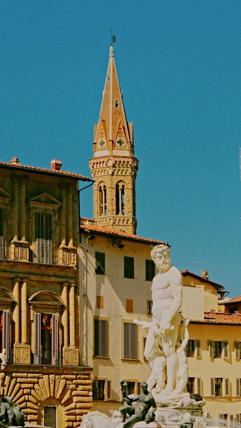 a po of a building in the background with a fountain and an old clock tower