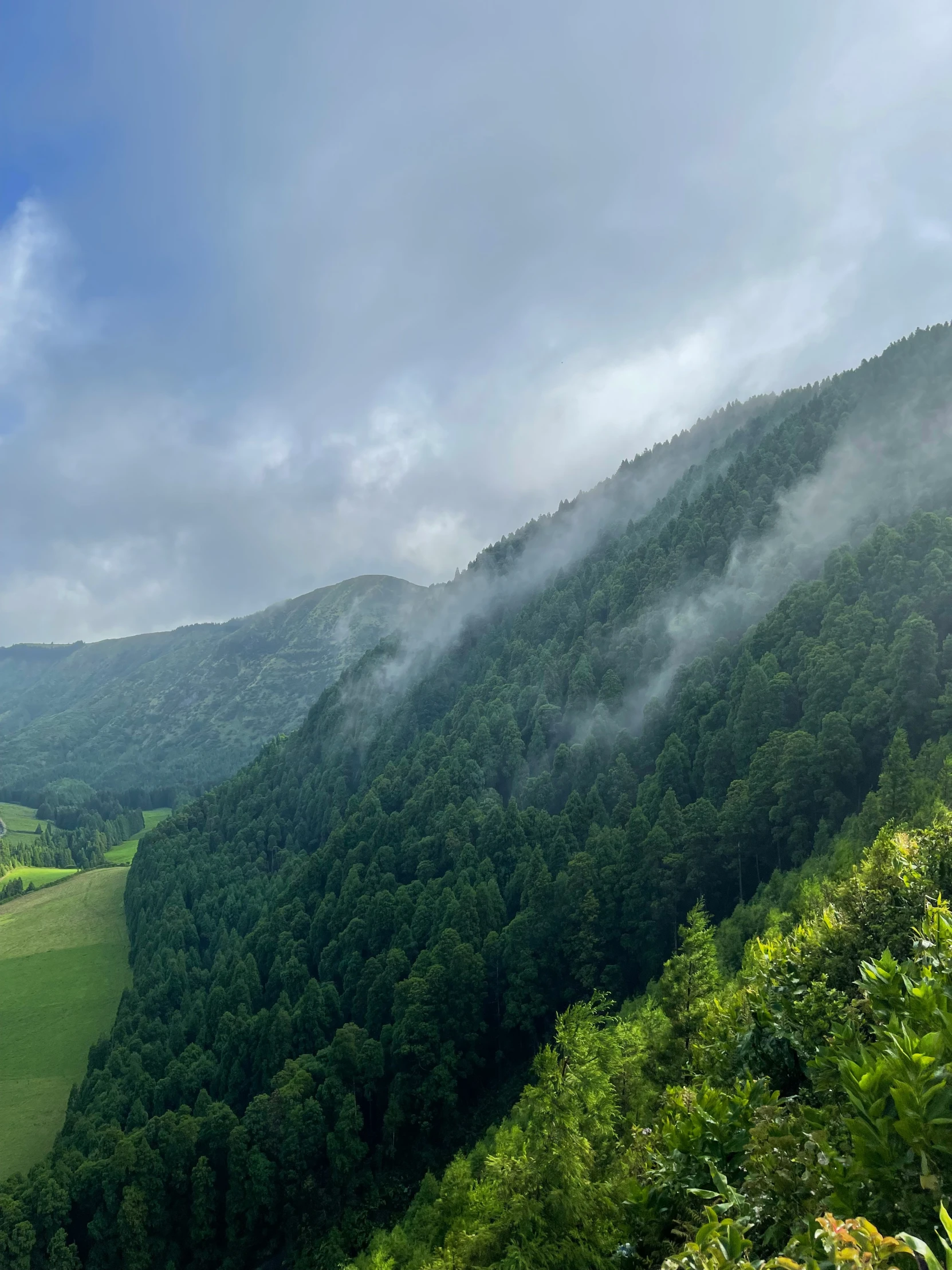 a mountain with mist hanging from the top